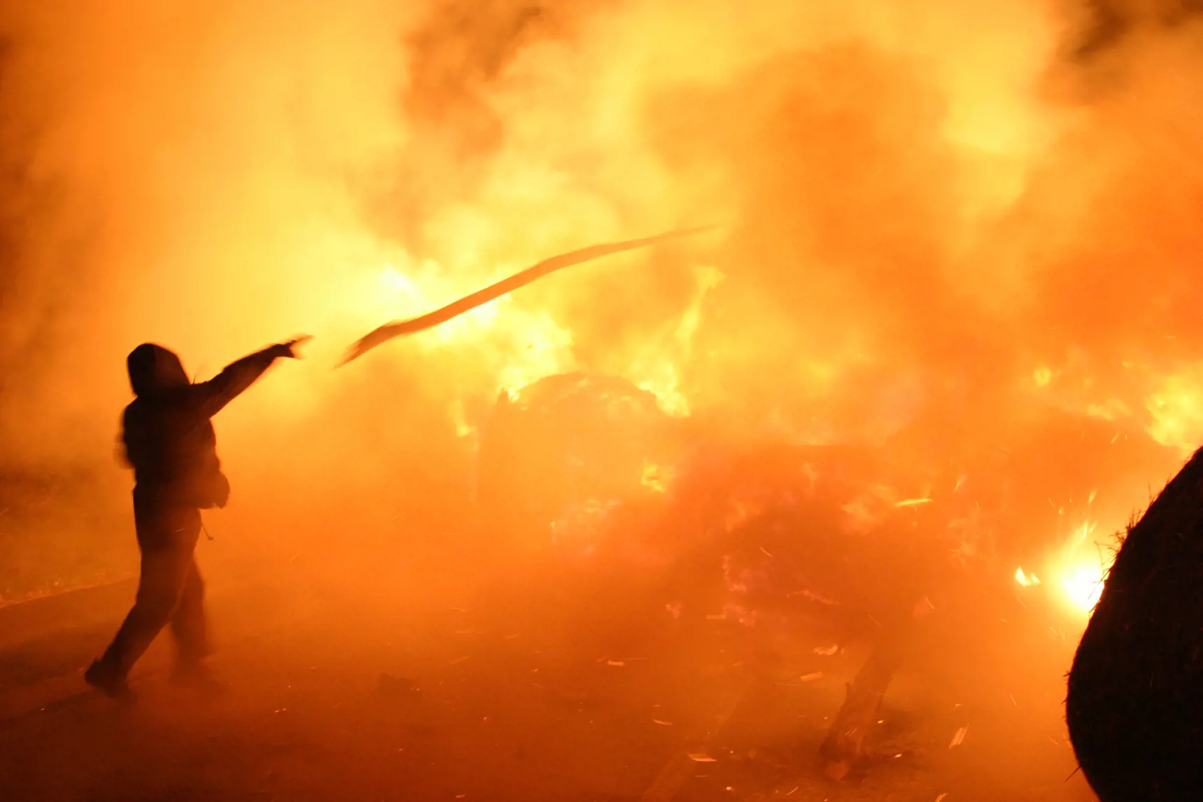 Image of a riot. Fire in the background.